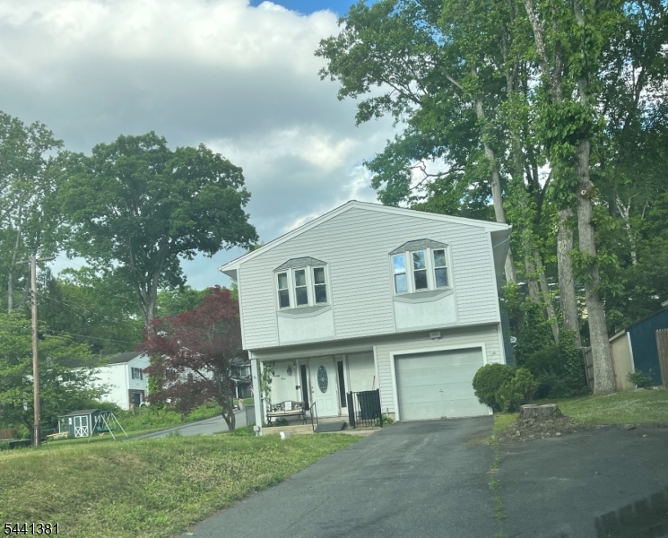 Opportunity Awaits in the Desirable Lake Hopatcong area!  This raised Ranch offers a versatile mother-daughter layout with two kitchens and handicap-accessible features, including a stair lift.  Recent improvements include new windows, siding , Central air, and a newer Septic system.  Situated on a corner lot with a fenced backyard, this home also features a one car garage and natural gas available in the street.  Perfect for commuters, with convenient access to Routes 80,46,and 10, as well as nearby trail service.  The interior provides a wonderful opportunity to update and customize to your personal style. Enjoy the benefits of prime location near outdoor recreation, including hiking, boating and all that the beautiful lake Hopatcong area has to offer  Bring your vision and make this home your own!!