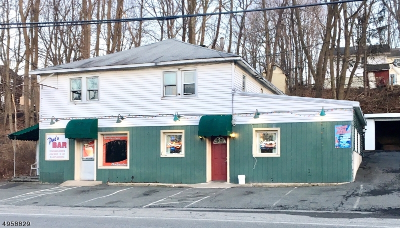 Well established local bar and restaurant with two attached rental units for sale. Liquor license and business also for sale through business broker. Income producing property. Family owned and operated bar in operation for 60+ years includes one of only 4 liquor licenses available in Mt. Arlington.  Two apartments attached to building.  Additional two family house and vacant lot adjacent to the property are also available, listed separately.