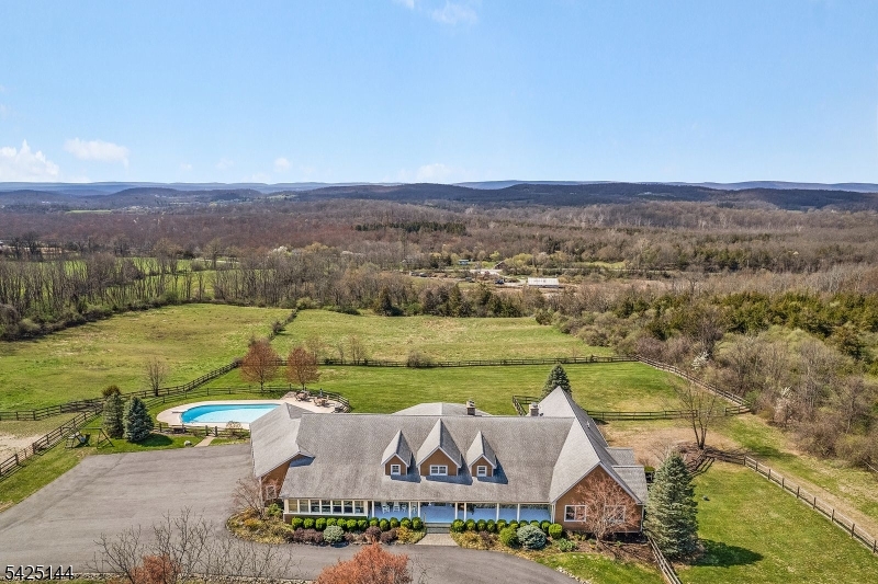 Sparta has a SECRET - it's 71 Kimble Lane!  You'll love this gorgeous, sprawling, custom ranch.  The quality of this home is remarkable.  With a panoramic view, in-ground pool and horse facilities, it is a fantastic retreat and sunsets are really AHHHHH-mazing!  Set on five acres, the beauty and privacy are unparalleled.  This FIVE THOUSAND SQUARE FOOT custom ranch was built with thoughtful attention and top quality construction shows at every turn.  With an open, easy flow, high ceilings, beautiful crown molding and custom detail throughout, this one is truly spectacular.  The full basement offers a world of possibilities and a fourth garage, too.  The roof and all windows are just a few years old and part of the top quality maintenance that is evident throughout.  Over 100 additional acres available!