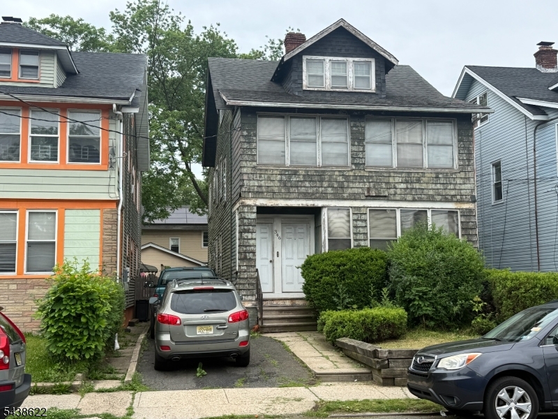 Unlock the potential of this spacious two-family home in the heart of Irvington. With some renovation and vision, this property offers tremendous upside for investors, owner-occupants, or buyers utilizing a 203(k) renovation loan.  Each of the two main units features 2 bedrooms, 1 full bathroom, an eat-in kitchen, dining room, living room, and sun parlor, providing generous living space and flexible layouts. The third level includes an additional 2 bedrooms and 1 full bathroom, offering even more possibilities.  Perfectly situated for commuters, the property enjoys convenient access to major transportation routes, including the Garden State Parkway, Route 78, and Route 22. Nearby bus and rail service provides easy access to New York City and surrounding areas.  Residents will appreciate the close proximity to parks, schools, houses of worship, shopping, dining, and other local amenities. Additional features include a full basement, a spacious backyard, and a private driveway with parking for multiple vehicles.  This is an excellent opportunity to add value and become part of Irvington's ongoing growth and revitalization. Don't miss the chance to transform this property into a standout investment or income-producing asset.