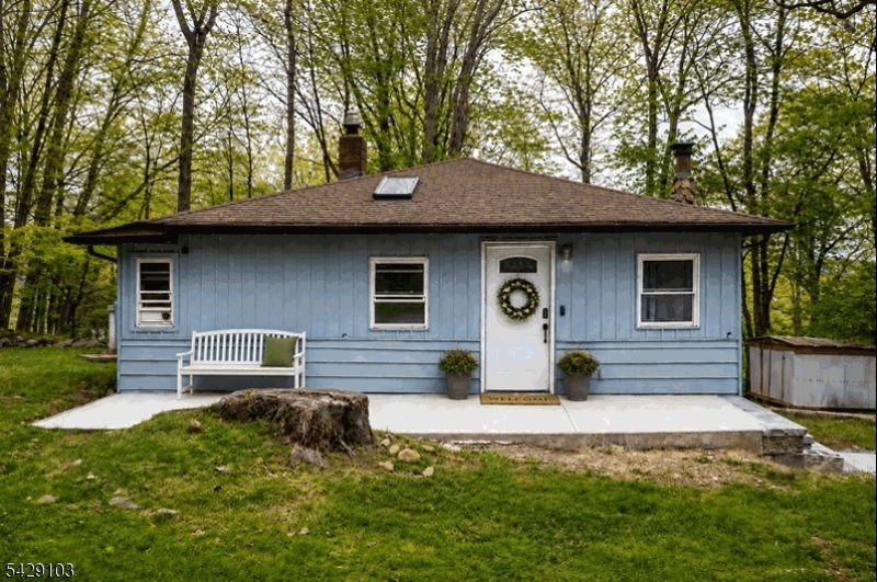 Nestled at the end of a quiet cul-de-sac, this 3-bedroom, 1-bath ranch offers an exceptional location defined by privacy, tranquility, and natural beauty. With a seasonal lake view of Lake Hopatcong, this home feels like a peaceful retreat perfect for those seeking serenity while still being close to everything. Included is the adjacent lot, providing even more space and potential. Enjoy your morning coffee out on the deck with plenty of privacy, taking in the peaceful, wooded setting. Inside, an updated open kitchen adds modern appeal and functionality, making the home move-in ready and inviting. A new front patio adds to the home's curb appeal. Conveniently located near Routes 15 and 80, this home is ideal for commuters while still offering that tucked-away feel. Located in desirable Roxbury Township with access to its well-regarded schools. Optional membership to Shore Hills Country Club allows you to fully embrace lake living with swimming, boating, and more. A rare opportunity to enjoy a serene peaceful home in an unbeatable location! Adjacent lot (21 Mohican) is included in the sale. Buyer is responsible for due diligence regarding zoning, permits and intended future use or improvements for vacant lot.