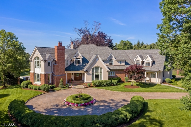 Sophisticated, enlivened, engaging. There is such a joy to this custom home that is approx. 9500SF, including the finished lower level. Privately set on 3 beautifully landscaped acres, there are gorgeous views to the Somerset Hills from the pool w/ sundeck & spa, expansive terrace w/ fireplace, kitchen, bathroom and outdoor shower. Indoors, varying height ceilings, window filled soaring walls, hardwood and marble floors, extensive millwork, fireplaces, and the gifted talents of an interior designer prevail throughout formal and informal spaces. The two-story foyer is followed by a welcoming area with bar. Cooking & gathering will be a delight in the expansive kitchen with high quality appliances, island with contiguous high-top table and large informal dining area opening to the terrace. Mahogany paneling and built ins distinguish the library. Ceilings in the dining room & great room are vaulted, the latter further detailed w/ shiplap & beams. The living room presents full carved-panel walls. Multiple French doors grant passage to the exceptional grounds. Located on the upper level, the 5 bedrooms are each accompanied with walk-in closets and bath. Luxurious Primary Suite w/ room-size closet opening to the updated bath offering quartz surfaces and a radiant heated floor. The lower level features; media & game areas, bar, wine cellar, exercise rooms, bath and tucked away utilities &mechanicals. The 4 car garage has an organization system and enjoys heating and air conditioning