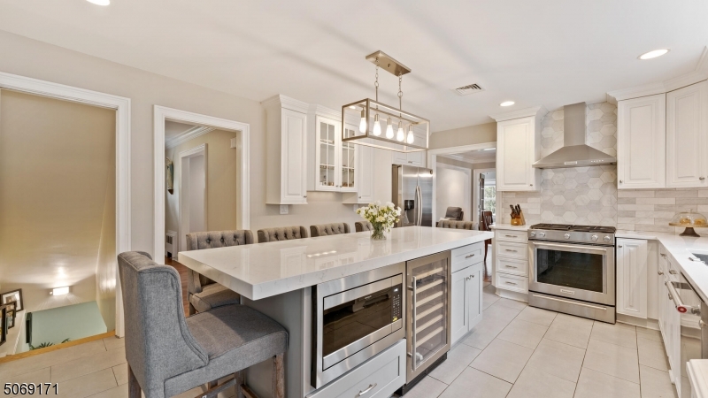 Classic Mid-Century side hall Colonial in convenient north side location.  Extensive 2013 renovations include roof, AC/heating units, wiring/ 4 zones, chimney & liner, 2 new baths.  2020 KITCHEN reno boasts quartz countertops including over-sized center island w/breakfast bar seating six, wine frig. & microwave; SS appliances including vented range hood; custom backsplash & tile floor! Gracious hardwood floors flow through the first & second levels. Charming French Doors lead to the family room w/volume ceiling & a wall of windows!  Lots of natural light through-out.  The basement sports new Lifeproof flooring in generous rec rm & office. Enjoy Westfield's proximity to NYC, NJ Transit train, dynamic town center & great schools!