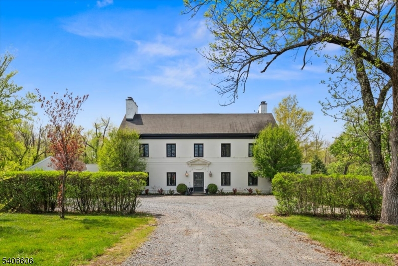 A timeless 1920's manor estate showcasing old world charm seamlessly enhanced with modern conveniences, set on 13 private acres just minutes from downtown Princeton. A long, tree lined driveway leads to this elegant three story residence offering 6 bedrooms, including a luxurious primary suite with wood burning fireplace, private balcony and an exceptional custom walk-in closet. This gracious manor features four wood burning fireplaces located in the kitchen, library, living room, and primary suite. Original architectural details including pocket doors, French doors, refined millwork, and bluestone terraces-worldly craftsmanship and enduring character. The home is filled with ideal east to west light, creating warm and inviting living spaces throughout. The newly designed kitchen incorporates today's modern amenities while honoring the home's historic elegance. Features include an oversized center island with a quartzite counter, Kohler farmhouse sink, Thermador appliances, custom millwork, and a wood burning fireplace. Living room has built in bookcases, custom lighting, and French doors to the sunroom and library. This home is ideal for both everyday living and entertaining. The breezeway was converted to a mudroom with Custom Pottery Barn-like organizational cubbies. The main level has a carriage house apartment offers a private entrance and separate utilities perfect.. The property also has a Pool house and a 3 car detached garage. ***NEW SEPTIC SYSTEM INSTALLED 06/2026