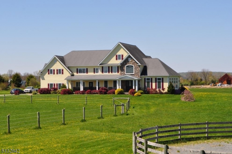 Distinctive & splendid Equestrian Estate in the Hills of Hunterdon  62+/- Preserved acres. 6200+/-SF custom built 4 bed, 4.5 bath manor home open first floor plan perfect for events with breathtaking farm views. Expansive home features refine teak wood floors, custom built cherry & walnut cabinetry elegant granite kitchen with double islands for food prep, casual dining & entertaining. 7 stall horse barn with rubber paver center aisle, fly-spray system feed room, heated wash stall, heated and air-conditioned office, tack room and viewing lounge wit kitchenette, laundry & shower. Oversized barn overhang can be enclosed for additional stalls, storage or equipment. 12096+/-SF arena constructed by Amish and features angled wooden side walls ample lighting for evening training & misting system to minimize dust. "Generac" house & barn.