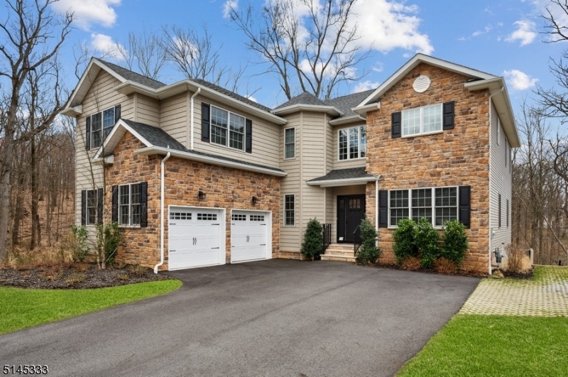 Luxury home in a private setting! Nestled at the end of a tranquil cul-de-sac bordering parkland in the coveted Reserve at Bel Air, this luxury home is surrounded by nature. Just a stone's throw to public transportation to NYC, the JCC Rec Center, schools & world-class shopping. One of the last homes built in this community in 2019, this highly desirable property offers 5BD/ 4 1/2BTH 2car garage & enormous privacy. A spacious, open floor plan, high ceilings, elegant details & luminous hardwood floors & crown molding throughout w/an abundance of natural lighting. The 1st floor offers an impressive 2-story foyer w/a beautiful quarter-turn staircase opening to a formal LR, DR & 1/2bath. The sun-filled gourmet kitchen is appointed w/white cabinetry, sleek granite counters, black tile backsplash, SS appliances & center island. From the adjacent breakfast nook, sliding glass doors open to the deck overlooking the private back yard w/views of the park & access to the Lenape trail beyond. The open flow continues to the FR highlighting a stone-surround gas fireplace. Completing the first level is a BD w/an en suite bathroom.On the 2nd floor you'll find a lavish Primary BD w/a tray ceiling, sitting area, double-walk-in closets & en suite BTH. This level has 3 addt'l BD, 2 more BTH one w/double sinks connecting two rooms & a convenient laundry room. The partially finished basement includes high ceilings, ample storage space & sliding glass doors to the back-yard patio & garden area.