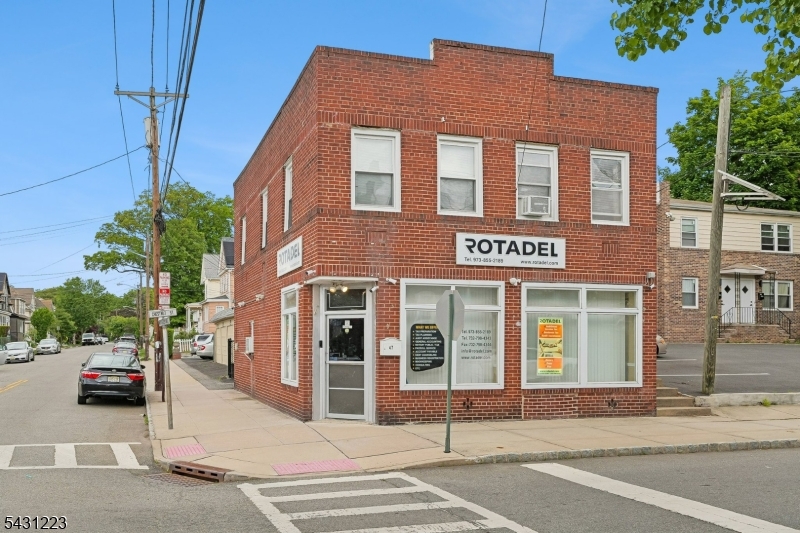 Exceptional & well maintained mixed-use investment all-brick building with street-level retail storefront currently occupied by a long-established accounting firm and a spacious 2-bedroom apartment above. Tenants have occupied the building for 10+ years, offering stability and consistent occupancy history. Property includes 5 garages plus additional driveway parking, creating additional income potential and convenience. Separate utilities for each unit. Ideal opportunity for investors or owner-occupants seeking supplemental rental income. See attached income/expense sheet for financial details.