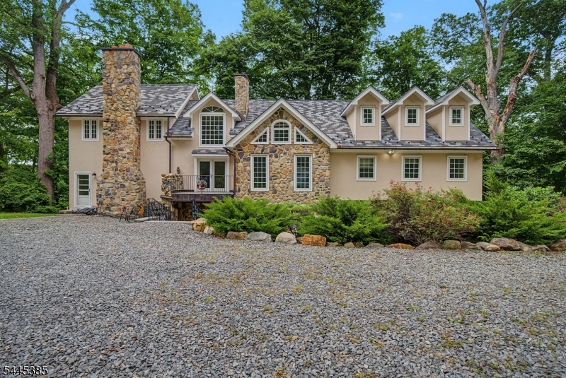 Welcome home to luxury and privacy in the highly desirable Troy Hills section of Parsippany. Nestled on nearly 2.5 private acres, this custom Mediterranean-inspired estate offers 4 bedrooms, 3.5 baths, with timeless craftsmanship.Inside, you'll find a gourmet chef's kitchen with Wolf & Sub-Zero appliances, custom KraftMaid cabinetry, radiant heated hickory hardwood floors, and elegant designer finishes throughout. Enjoy cozy evenings by the stunning fieldstone fireplace and effortless entertaining with a whole-home audio system.Step outside to your own private oasis featuring an in-ground pool, beautiful bluestone patios, mature landscaping, and exceptional privacy. Complete with a 2-car detached garage, expansive grounds, and an additional lot at Dogwood Ln. & Thompson Rd., this property offers a rare opportunity to own a truly one-of-a-kind estate.Conveniently located near major highways, shopping, dining, parks, and top-rated schools.