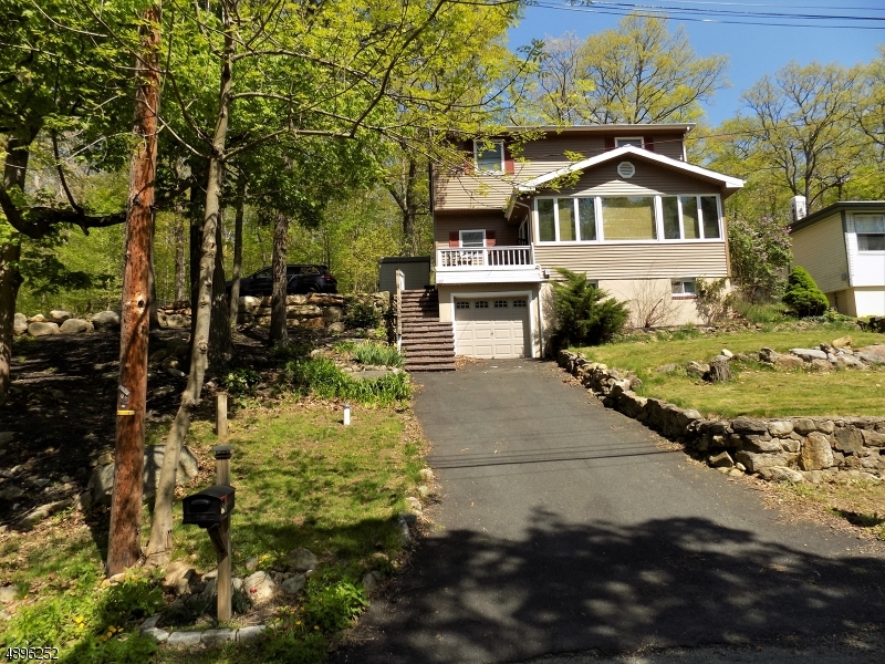 WALK TO THE LAKE!!  SO MUCH CHARM IN THIS HOME.  ENJOY THE VIEWS WHILE DINING, COZY UP TO THE FIREPLACE IN LR, EXTRA ROOM ON FIRST FLOOR IS IDEAL GUEST ROOM OR OFFICE, 3 BEDROOMS UPSTAIRS WITH AN EXTRA SPACIOUS MASTER.  UPDATED FEATURES INCLUDE FURNACE, CENTRAL A/C, 2 BEDROOM SEPTIC, FENCED IN BACKYARD & BOTH DRIVEWAYS WERE RECENTLY PAVED. PARTIAL FINISHED BASEMENT HAS LAUNDRY ROOM, TOILET AND SINK AND STORAGE.  ATTACHED PARTIAL GARAGE IS USED FOR STORAGE.  LAKE MEMBERSHIP IN THE EAST SHORE PROPERTIES OWNERS ASSOC IS OPTIONAL BUT OFFERS A BEACH AREA AND DOCKS FOR BOAT OR OTHER WATERCRAFT.