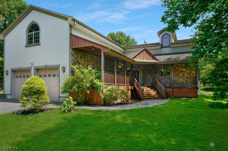 A custom home situated on 42+ private acres, this unique residence was built with quality in mind.The mahogany & stone front porch draws one into the impressively large open concept 1st floor w/ 24ft cedar ceilings & Brazilian cherry flrs. A Large kitchen boast custom cherry cabs, SS appl & island overlooking the family rm w/ floor to ceiling stone fireplace showcasing a heatolater & entmt center. 1st floor master suite w/ 2 walk-in closets. All rooms are oversized including the garage w/ 14ft doors, basement & workshop w/ 3rd garage. 5 zn radiant floor heat throughout incl basement & garages, 400 amp electric service, 3 AC units & outdoor wood furnace. The exterior features a horse barn w/ elc & water, 2 stall shed row, 75x100 riding ring, pastures w/ 2 run-in sheds +trails. A truly unique & custom property.