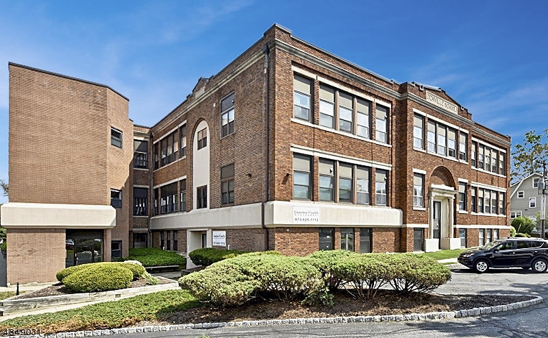Location, Location, Location!  Commuters take notice! Here is the location you've been looking for, this unit in this classic converted Schoolhouse!  One Oversized bedroom with LOTS of closets, updated kitchen and bath and spacious living room dinning room combo makes this an amazing condo to call home!  Kitchen and bathroom updated in 2010.  Really well maintained unit on desirable 2nd floor.  Walk to town, shopping, restaurants.  Easy access to major highways Routes 80 & 46. Laundry facilities on same floor.  COMMUTER DREAM!  Water included in maintenance fee.