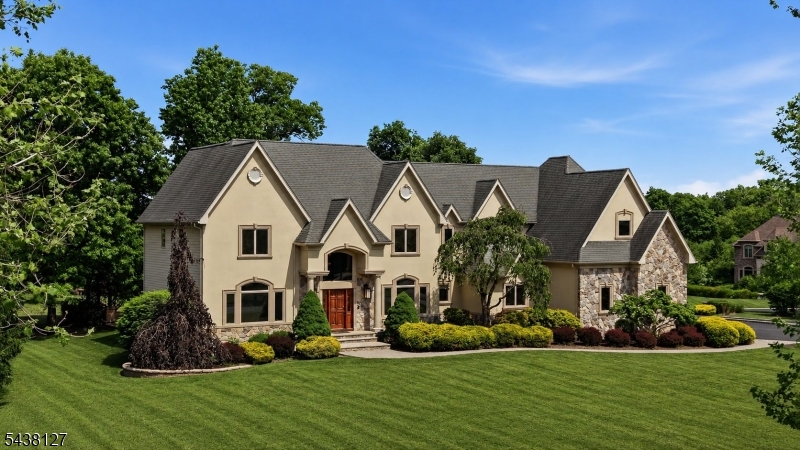 Welcome to 2 Michele Crossing, a distinguished custom-built residence nestled on 2.5 private acres on a cul-de-sac street in the prestigious Equestrian Meadows community of Raritan Township. Lovingly maintained by its original owners, this exceptional home offers timeless design, quality craftsmanship and an elegant floor plan designed for both everyday living and grand-scale entertaining. A grand marble foyer welcomes you into the home, flanked by formal living and dining rooms. The private library features custom built-ins while the dramatic two-story family room showcases a gas fireplace and abundant natural light. The gourmet kitchen is appointed with granite countertops, a large center island, professional-grade stainless steel appliances and an adjoining butler's pantry. The first floor offers a private office that can serve as a fifth bedroom located next to a full bath, along with a powder room, laundry room, and both front and rear staircases. The luxurious primary suite features hardwood flooring, a sitting room, dual-sided fireplace, walk-in closets and a spa-like bath with jetted tub, oversized shower, dual vanities and private water closet. A princess suite enjoys its own bath, while two additional bedrooms share a hall bath. Outdoor living is highlighted by an expansive patio with cedar pergola and lighting, perfect for entertaining or relaxing. Additional features include a 3-car garage with new epoxy flooring, extensive hardwood flooring and custom millwork.