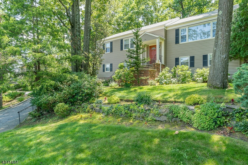 This well maintained home is located on a quiet tree lined  street in a desirable section of West Orange. The home features gleaming hardwood floors in the living room and dining room. The kitchen is bright and leads out to an oversized deck over looking a  picturesque backyard. Both the master and main bath have been renovated. You will find neutral carpet over hardwood floors in the three bedrooms on the first floor. The lower level has a large bedroom, family room with built in shelving and gas fireplace, laundry room and updated powder room. The oversized garage has a storage area.