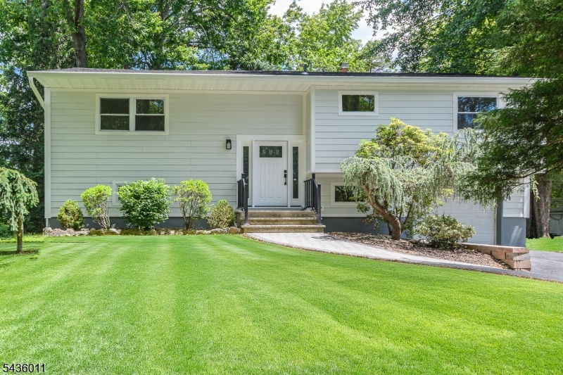 Beautifully renovated bi-level home featuring 4 bedrooms and 2 full bathrooms. The stunning new kitchen boasts a center island, brand-new appliances including a dishwasher, refrigerator, gas range, and built-in microwave. Refinished hardwood floors add warmth and elegance throughout the main level. Both bathrooms have been completely updated with modern, high-end finishes. The first-floor bath offers convenient access from both the primary bedroom and hallway and features dual sinks. The ground level includes a spacious family room with sliding glass doors leading to a private backyard patio, as well as a fourth bedroom perfect for guests, a home office, or extended living space. The ground-floor bathroom includes washer/dryer hookups for added convenience. Move right in and enjoy this beautifully updated home!