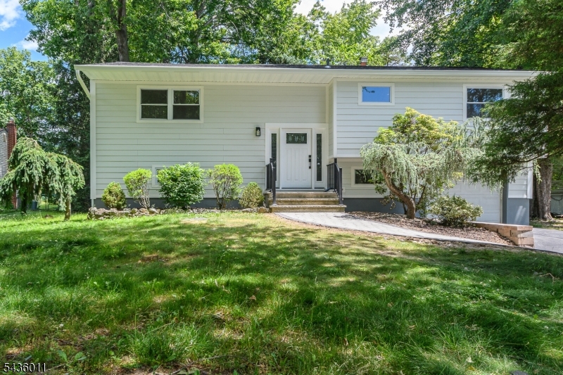 Beautifully renovated bi-level home featuring 4 bedrooms and 2 full bathrooms. The stunning new kitchen boasts a center island, brand-new appliances including a dishwasher, refrigerator, gas range, and built-in microwave. Refinished hardwood floors add warmth and elegance throughout the main level. Both bathrooms have been completely updated with modern, high-end finishes. The first-floor bath offers convenient access from both the primary bedroom and hallway and features dual sinks. The ground level includes a spacious family room with sliding glass doors leading to a private backyard patio, as well as a fourth bedroom perfect for guests, a home office, or extended living space. The ground-floor bathroom includes washer/dryer hookups for added convenience. Move right in and enjoy this beautifully updated home!