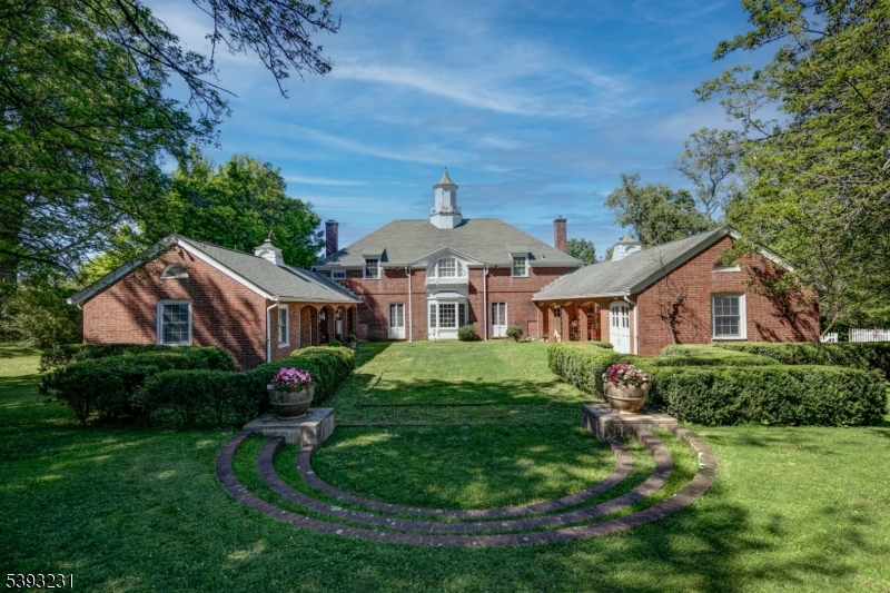 Historic 100-year-old carriage house ready for new vision on 8.7 acres of storied property.  Originally part of the family compound where the United States Golf Assn Museum now resides.  The century-old setting frames the converted carriage house with extraordinary character. Designed by John Russell Pope in 1919, this red brick structure with center courtyard was partially renovated in 2010 and is currently a residence with six bedrooms, six baths, office/den, open-concept living grand great room/music area.  Two en suite bedroom suites are located on the first level. The majestic land offers spectacular privacy and an unsurpassed pedigree for the rebirth of a twenty-first century masterpiece. The next steward of the historic site can append new construction to the existing fine design and blend today's desired amenities with the charm of a century ago in perfect harmony.  Architectural drawings are available for a magnificent re-design with addition totaling 10,000 square feet of living space.  The pedigree of this beautiful haven is extensive and an extremely rare find. An unbelievable lifestyle awaits a new owner with vision and desire to dwell on a piece of history amidst the Somerset Hills.