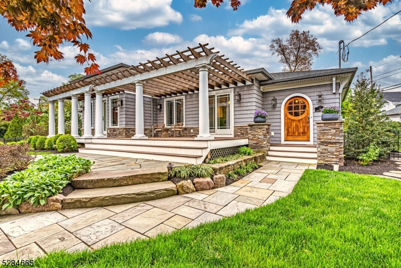 Beautiful, Sprawling, Updated Ranch in the desirable Indian Lake community! Step into this secret garden through a wooden arch & gorgeous gates. Fabulous Open Living Space. Large, Welcoming Foyer w/Unique Arched Wooden Door welcomes you in to the living room w/tray ceilings & a STUNNING stone faced gas fireplace. Bright Kitchen w/Granite Counters & High End SS Appliances. Center Island, Bar Seating, Glass tiled backsplash & open wooden shelves. Dining area w/french doors lead to composite deck & pergola which eases the transition from living indoors & out. 2 toned cabinets & brass hardware carry the charcoal & white tones throughout the home. Freshly painted. New, modern HW flooring & solid custom wood doors w/crystal door knobs throughout. Gorgeous light fixtures compliment the design w/gold & black finishes. 3 generous sized bdrms equipped w/lots of closet space. A grand & indulgent primary suite showcases high ceilings, automatic blinds, a custom walk-in & bath w/an oversized spa shower. Flexible Finished BSMT. Family room, wet bar, laundry & 3rd full bath. 2 Car Garage & TONS of storage! Stunning landscaping & so many extras completed w/quality craftsmanship. Cross the street & paddle to all Clubhouse & Beach Activities. Stones throw from diving board beach & Bistro. You can't beat the location. Convenient to everything! Just mins to public transportation -NYC-Direct train & bus, major hwys, grocery store & great restaurants/shopping in DWTN Denville. NOT IN FLOOD ZONE.