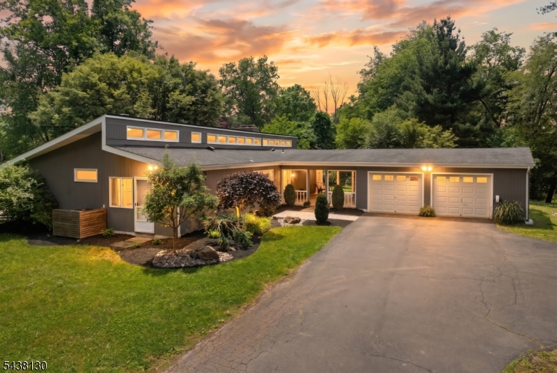 Nestled on 4.98 sprawling acres in Hillsborough, this completely reimagined ranch is a nature & bird lover's dream come true. Backing directly to state land with fruiting and flowering trees, abundant wildlife at every turn, and absolute privacy, this is the one-of-a-kind retreat you've been waiting for. Vertical cedar siding, a stunning paver patio with fire pit, charming chicken coop, and a refreshing above-ground pool make the outdoor experience as extraordinary as the home itself, a true sanctuary unlike anything else on the market. Inside, the fully renovated open floor plan dazzles with architectural lighting, added windows that flood every room with natural light, and crisp board and batten wall detailing throughout. The showstopper kitchen features quartz counters with a dramatic waterfall edge, a built-in coffee maker, speed oven, sleek induction stove, integrated wine cooler, and premium Miele appliances. The living and dining areas flow seamlessly together, anchored by a cozy wood-burning fireplace and recessed lighting. Three bedrooms and two fully updated baths include a master suite with a brand-new full bath and a guest bedroom with custom built-in organizers and three closets. A unique parlor with a striking concrete sink and accent wall adds personality and character you simply won't find anywhere else. Other features include an EV charger, generator outlet, finished basement with spare room, and two-car covered garage to complete this breathtaking escape.