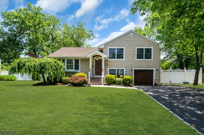 Welcome to this spacious expanded split-level home located on a beautiful tree-lined street in the desirable Brunner section of Fanwood. The main level features a spacious formal living room that flows seamlessly into the open-concept kitchen, dining area, and expanded large family room complete with a cozy gas fireplace. Sliding glass doors off the family room lead to a great backyard perfect for entertaining or relaxing. Just off the kitchen on the ground level you'll find a highly versatile secondary bonus room, ideal for an office space with a full bathroom, large pantry, garage and yard access. Downstairs the fully finished basement offers excellent additional living space perfect for a game/toy room, beautifully optimized with a custom storage system for effortless organization. The upstairs features three generously sized bedrooms and a full bathroom. Each bedroom is equipped with California Closet systems designed to maximize storage and functionality. This home is truly move-in ready and waiting for its next owner to unpack and enjoy!