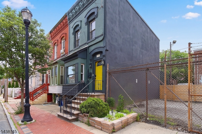 Welcome home to an elegantly renovated 2-bedroom row house-style apartment located on one of Newark's most historic streets. This residence seamlessly blends modern upgrades with timeless character and charm. The first floor features a spacious living room, formal dining room, and updated kitchen. Exposed brick accents in the living and dining rooms add warmth, texture, and a distinctive urban feel that elevates the interior. The second floor offers two generously sized bedrooms, a dedicated office perfect for working from home, and a beautifully renovated oversized bathroom complete with a double vanity. A private backyard provides the ideal space for outdoor relaxation, gardening, or entertaining. Conveniently located near the train station, the Prudential Center, and the renowned Tops Diner, with easy access to major highways, this exceptional home offers the perfect combination of historic charm, modern comfort, and commuter convenience.