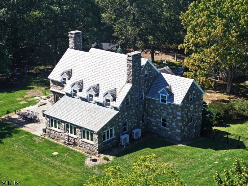 Ready for spring? WE ARE! BRAND NEW FURNACE & updates! Timeless elegance & storied charm. Rare 5-BR, 6-bath stone "castle" nestled on over 21 private subdividable acres. 1 of a kind property blends vintage character w/ modern comforts, offering mtn views, original architectural details & rm to live, entertain & explore. Orig stone guard house hints at estates notable past, once occupied by nuns & still echoing w/ remnants like old confessional! All 5 BR feature pvt baths. Original custom doors, light fixtures, pewter railings & rare pewter chandelier. Patio incorporates historic local mill stones, 1 beautifully crafted into sun dial. Stone sunroom w/ original lights & doggie door to fenced yard for 4-legged companions. LR w/ stone FP & custom mantle. Granite kitchen, pantry & back staircase once used by butler for seamless access. 2 BR, office & add'l laundry located on main floor. 2nd level hosts custom sauna, 3 spacious BR, incl primary suite w/ breathtaking views. 3rd floor currently used as tranquil yoga rm. Basement incl 2nd laundry, billiard, game rm & more. 2-car attached garage. Mini-split systems throughout for energy-efficient A/C & auxiliary heat. Multiple outbuildings. Space for gardens, trails or potential equestrian use. Rare estate offers once-in-a-lifetime opportunity to own piece of Sussex County history while enjoying comforts of modern updates. Whether you dream of a private retreat or legacy property, castle delivers unmatched charm, privacy & versatility.