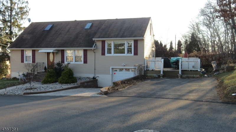 Charming move in ready exp. cape on over 1/2 acre corner lot. Great curb appeal and is deceivingly large with 3 bds and 2 f/bths. Main level has 2 bds, f/bth, formal living rm, open dining rm to Family rm, kitchen, red oak hardwood flooring throughout and remarkable full finished basement with f/bth, laundry room and utility room. New Furnace in 2019 & new water heater 2018. Newer Kitchen w/granite, new blacktop driveway 2017. Stamped concrete walkway, front steps, driveway and retaining wall (2012). New engineered deck with radiance railing, new siding (R5), new  garage door (R12), and new gutters all in late (2009). Central air, reverse osmosis H20 in kitchen, huge yard, extra attic space. Must see if looking in Rockaway Boro!