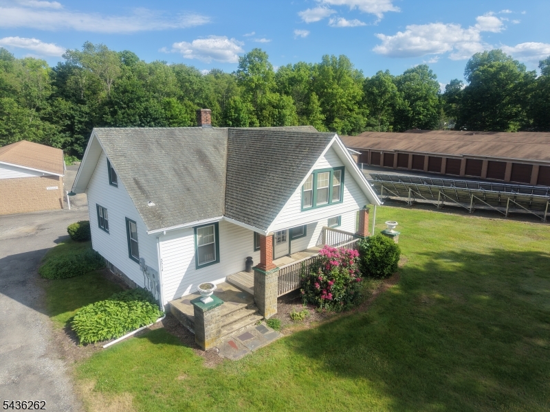 Welcome to 5514 Berkshire Valley Road, a charming Cape Cod-style home set on a beautiful 0.68-acre lot backing directly to protected forestland. Offering privacy, peaceful surroundings, and stunning sunset views, this home delivers a true retreat-like living experience.Inside, the home features 3 bedrooms and 1 full bathroom with a warm and inviting layout. The main level includes a bright living room, a formal dining area, and a functional kitchen filled with natural light, creating an easy and comfortable flow for everyday living.The lower level provides additional flexible space ideal for storage, recreation, or a home office setup, offering added functionality to the home's footprint. Thoughtful finishes and modern flooring enhance the overall comfort and appeal. Step outside to enjoy a fully fenced backyard and a private deck overlooking the wooded landscape, perfect for relaxing, outdoor dining, or entertaining. Conveniently located while still offering a private, nature-filled setting, this home blends comfort, space, and tranquility. Rental includes the main residence, driveway parking, and yard area. Detached garage storage structures are excluded from the lease and reserved for the owner's use.