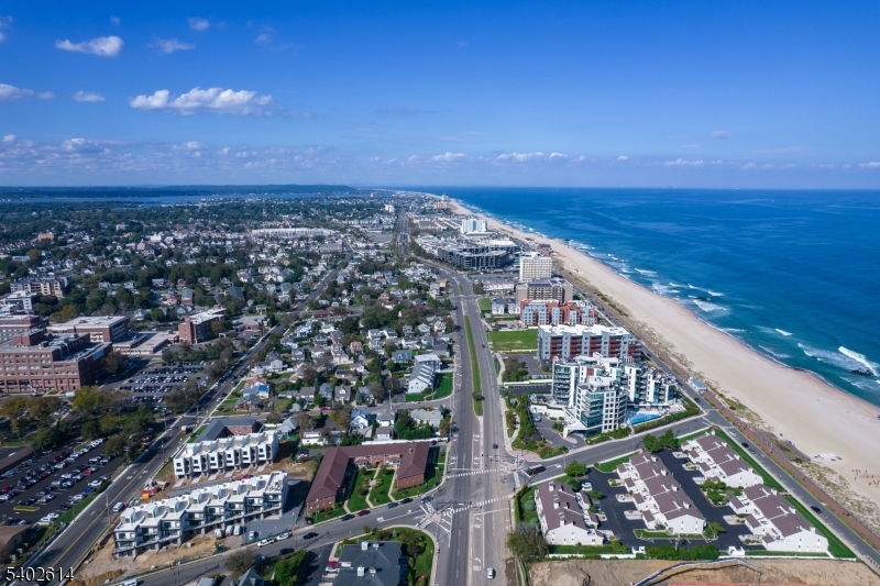 New Construction! Experience Unparalleled Luxury Living at The Seashore in Long Branch! Ride your private in-unit elevator up 4 levels to your expansive rooftop terrace & savor sweeping ocean views. Just minutes from the beach & Pier Village, this limited collection of 14 luxury townhomes offers close to 3,200 sqft of designer interior living space (+1108 SF outdoors) with 3 bedrooms + den, 3.5 baths, multiple balconies & a heated, EV charger ready garage. A modern masterpiece, each home features custom European windows and doors, open-concept living, and a chef's kitchen with premium smart appliances: Nostalgie by ILVE stove & SAVALO refrigerator and dishwasher.After a day at the beach, relax in the exclusive heated resort-style pool or explore the vibrant dining, shopping, and nightlife of Pier Village, Red Bank, Asbury Park, and Sea Bright, with NYC just a ferry ride away. Located minutes from the future home of Netflix, this is coastal luxury at its finest!