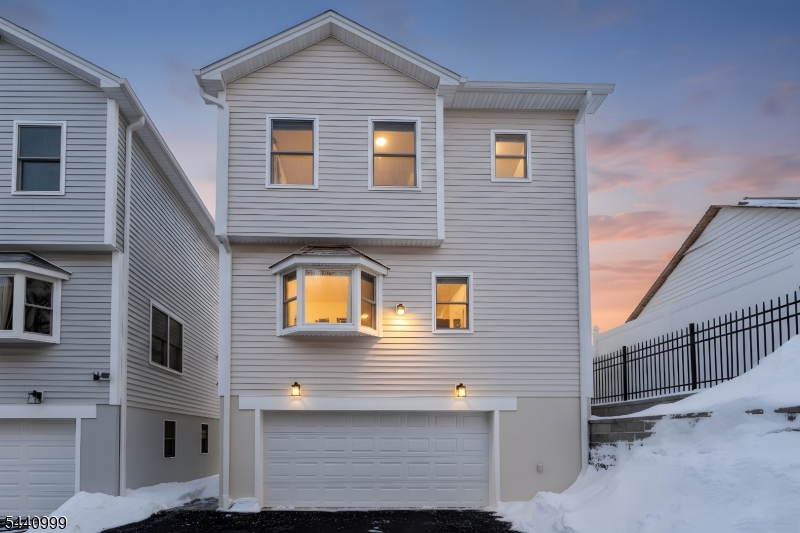 Welcome to The Estates at 5th Avenue, where modern luxury meets smart affordability in this brand new 2025 construction designed for comfort,efficiency, and elevated living. Step inside to discover 9-foot ceilings with elegant crown molding, rich hardwood flooring throughout, and recessed lightingthat creates a warm, upscale atmosphere on every level. The thoughtfully designed layout offers 2 spacious bedrooms and 2.5 bathrooms, including privatesuites with walk-in closets and baths featuring premium Kohler and TOTO finishes. The heart of the home is the beautifully appointed 10 12 kitchen, completewith a sizable pantry and high-end Whirlpool appliances perfect for both everyday living and entertaining. Pre-installed TV hookups, a dedicated laundryroom, and abundant closet space add everyday convenience. Comfort is effortless with central HVAC and 3-zone climate control, allowing you to customizetemperatures on each level. A security system, covered porch, and 2-car garage enhance both privacy and peace of mind. One of the standout advantages? A30-year tax abatement, keeping ownership costs significantly lower. The low $150/month HOA covers exterior maintenance, landscaping, irrigation, snowremoval, lighting, and more giving you a low-maintenance lifestyle. Located with direct public transportation to NYC, Hoboken, and Jersey City, and close toschools, dining, and shopping. Luxury. Efficiency. Value. Make this exceptional opportunity yours before it's gone.