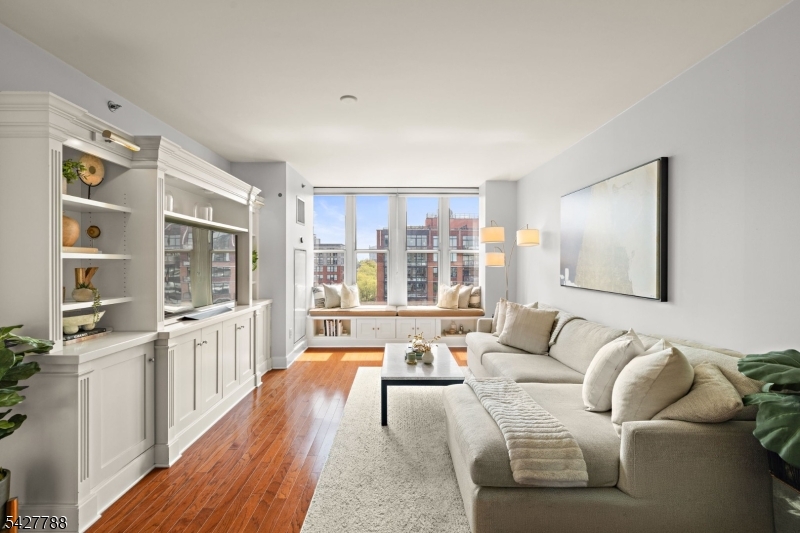 Welcome to 1125 Maxwell Lane #1115 an expansive and beautifully updated 1-bedroom, 1.5-bath residence offering approximately 1,080 square feet, one of the largest one-bedroom layouts in the sought-after Maxwell waterfront community.A renovated foyer sets the tone, leading into a sun-filled living and dining area with oversized windows and prized southern exposure, bringing in exceptional natural light throughout the day. The updated kitchen features stainless steel appliances, sleek cabinetry, and modern finishes, perfect for both everyday living and entertaining.The spacious primary suite offers a serene retreat, complemented by a renovated bathroom, while the additional half bath adds convenience for guests.Residents enjoy full-service amenities including 24-hour concierge and security, a fitness center, two outdoor pools with jacuzzi, resident lounges, a movie theater, landscaped outdoor spaces, and BBQ/grill areas. A private shuttle to and from the PATH enhances everyday convenience.Ideally located near the NYC ferry, PATH, buses, parks, and top-rated schools, this home offers the perfect blend of space, luxury, and waterfront living.