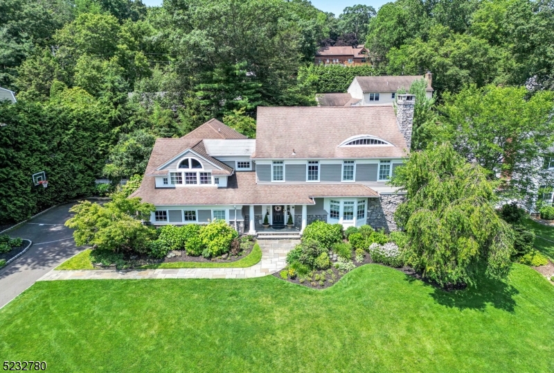 Prepare to be impressed - pristine 4 BR, 3.5 BTH Colonial in Ridgewood's top rated Willard school district. Steps from the Elementary School, NYC bus/train and tennis courts, this renovated Colonial offers the perfect blend of classic architecture with modern living. Entertaining is a joy " first floor offers a great flow w/a lrg Entrance Foyer, leading into the Dining Room overlooking the manicured yard. Recently renovated Eat-in Kitchen is a chef's delight, top-of-the-line appliances, b'fast bar, adjoining butler's pantry. Mudroom with laundry gives easy access to the driveway. Living Room features a wood burning FPLC, flanked by built-ins. Adjoining Den with wainscoting, a wall of built-ins. French doors lead into a sun-filled Family Room with Dutch Oven, 3 walls of windows, overlooking the outside entertaining oasis. 2nd floor boasts 2 primary suites with en-suite baths. The first showcases elaborate moldings, offers a BR,  sitting room w/FPLC, lge walk-in. Primary bath w/recessed ceiling, soaking tub, stall shower. The second en-suite features vaulted ceilings, exposed beams, custom built-ins with office space. En-suite bath with lge stall shower. 2 add. BRs are well sized w/built-ins, crown moldings, recessed ceiling. Full basement is waiting to be finished, full height ceilings, access to yard. Enjoy alfresco dining beneath the pergola,  drinks in front of the outdoor fireplace. 2-story playhouse and hot tub. This home with its outdoor oasis was built to impress!