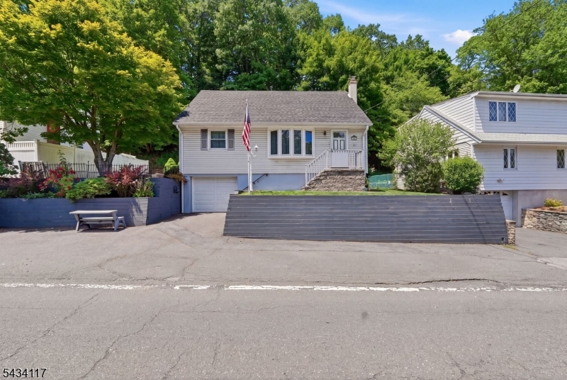 This comfortable and cozy 3-bedroom Cape has been well maintained, beginning at the top, with a newer roof and rebuilt chimney. This home features a welcoming foyer, and the living room boasts a warm, decorative brick accent wall. The large picture window makes the LR a bright and sunny one! The kitchen has been beautifully upgraded and is fully equipped with all the necessary appliances. Access to a large deck is provided through a convenient door, and shuttered window treatments add the perfect touch. Each bedroom features double closets, with the primary bedroom being extra large, complete with two lighted double closets. The basement is clean, and the built-in garage provides added convenience when entering from the driveway. The full tiled bath has a heat lamp for those chilly mornings. The property is serviced by a well, with connections already in place for public water use. Public Sewer. Rear property line ends approx at the tree line. Some upgrades: CAC 2021, Chimney/roof. 2021. There is a one car drive PLUS 3 off street parking spots