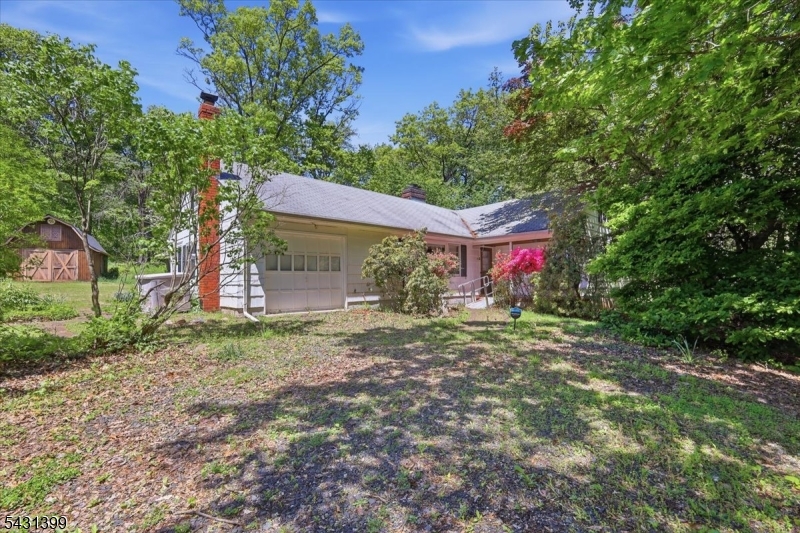 As you turn onto Roosevelt Road, the surrounding trees create an immediate sense of privacy and separation. Set on 5.12 acres, 9 Roosevelt is surrounded by woods and open space that make the property feel peaceful and secluded. Through the front door, the living room, filled with natural light, flows into the dining area and kitchen, creating a layout that offers strong potential for someone ready to reimagine the space. The main living areas connect comfortably together, providing a solid foundation for everyday living and future improvements that could completely transform the home. Down the hall, three bedrooms provide comfortable living spaces, while the full bath is centrally located to easily serve the home. Outside, the land becomes the true centerpiece of the property, offering over five acres of privacy, open space, and wooded surroundings that are increasingly difficult to find. Whether your vision includes enjoying the quiet of nature all around you or expansion, the setting provides an opportunity to create something truly special. It's the kind of property where the value is not just in the home itself, but in the space and possibilities that come with the land. Whether you are looking to restore or create something entirely your own, this property offers the rare combination of privacy, acreage, and opportunity just minutes from everyday conveniences, major commuting routes, and the small towns, farmland, and lifestyle that make Hunterdon County so lovely.