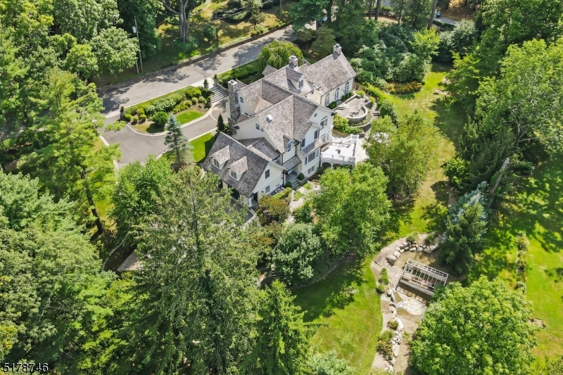 Spectacular setting on prestigious, Hathaway Lane in the Heart of Essex Fells. Voted one of the best places to live in NJ! This magnificent grand colonial is completely renovated and expanded with the highest attention to detail and exceptional quality. Featuring 6-7 bedrooms,7.1 baths, 4 car gar on 1.3acres of park-like property. Stunning foyer welcomes you, a large formal Dining rm w/fireplace&sun drenched banquet size Living rm w/oversized windows,french doors access upper&lower blue-stone patios overlook sweeping lawns&verdant property w/mature plantings, a perfect floor plan for large scale entertaining. Gourmet  kitchen w/professional appliances,large center island,butler pantry,informal dining all open to family rm w/access to deck&patios, perfect for large gatherings. perfectly secluded Office w/fireplace. Entertaining areas flow perfectly to outside decks,patios&sprawling yard for living&entertaining at its best! Beautifully appointed laundry,mud& powder rms, front&back staircases complete the main level. Spacious Primary suite features seating rm, large architectural windows, WIC, spa bath w/soaking tub. Additional en-suites&guest quarters are beautifully appointed&flow seamlessly. LL features rec rm,exercise rm,game rm,summer kitchen,custom designed wine cellar&bonus multipurpose rm/bedrm, full bath&multiple French doors access patios,deck&property. Easy commute to NYC,shopping,restaurants&top-rated schools. This is the Estate Living that you have been dreaming of!