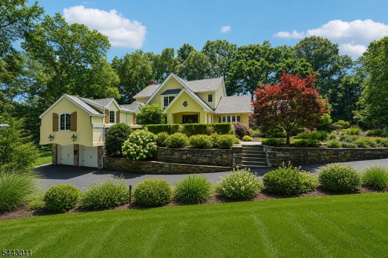 1.2 acres with lovely water views! You will fall in love with this elegant & sophisticated HOME, featuring a stone, brick & stucco exterior painted in 2024, new bluestone walkway & a brand-new roof. Enter the tiled Foyer w/tray ceiling and appreciate the crown moldings, solid wood doors, arched doorways. The gourmet kitchen has eastern exposure, bringing in sunlight, and features a center island, heated tile floor, Sub-Zero refrigerator, professional-grade stove, S/S double oven, microwave, wine cooler, water filtration system, granite counters, and a huge pantry. The adjoining Great Room showcases a coffered ceiling and large windows, making for a wonderful flow for entertaining. Banquet-sized FDR with a stone fireplace, french doors lead to a cozy 3-season room with slate floor, exposed brick, and 2nd fireplace. First-floor primary BR has a tray ceiling w/lighting and a large walk-in closet/dressing room. Marble bath w/tub & oversized shower; 2nd br/office. Upstairs, you will find soaring 10 ft. ceilings, 2 additional bedrooms (one super-sized), a gathering area, and bonus room, a marble bath w/tub and a separate shower. Huge finished basement has a 3rd fpl.,wet bar, office nook, and very spacious laundry room. Gleaming HW floors throughout, recessed lighting, 3-zone heat and C/A., security system, water softener, outdoor lighting, barbecue, slate patio. Circular drive w/ belgium block curbing. Room for a pool. Great location close to Wyckoff town center. Must see!