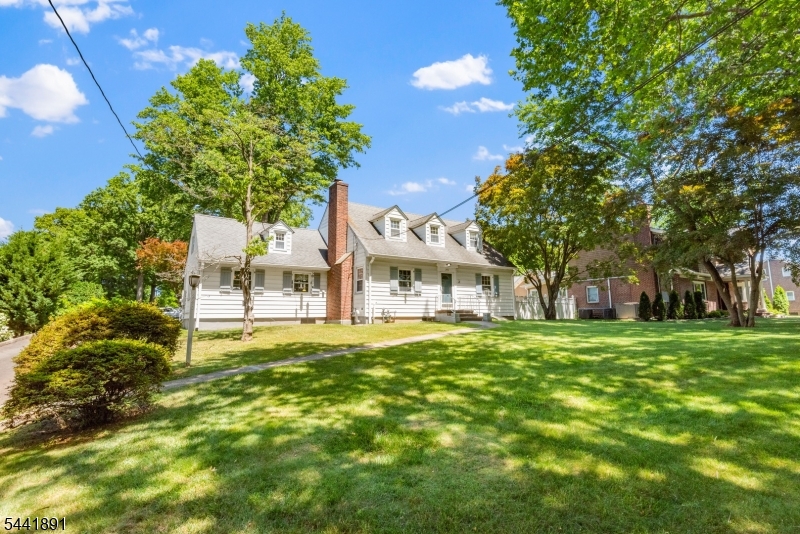 Set on approximately 1.09 acres, 240 Summit Avenue in Mountainside, NJ offers a rare combination of space, versatility, and convenience. This Cape Cod residence provides 5 bedrooms, 3 bathrooms and approximately 1,723 sf with multiple areas designed for everyday living, work, and entertaining.The main level features a spacious eat-in kitchen, formal dining room, living room with wood burning fireplace and 2 nicely sized bedrooms. A three-season room overlooks the park-like grounds, creating a seamless connection between indoor and outdoor living. Upstairs level includes 3 bedrooms with the primary having a massive dream closet, one bedroom is smaller, perfect for an office or twin bed. The finished basement includes a summer kitchen, wet bar, recreation room, and workshop.Outdoor amenities include a deck and three garages. Recent improvements include a new roof over the three-season porch and seal coated driveway. Systems include a Will McLean hydronic heating system, a Generac whole-house generator, and a Tesla wall connector for EV charging. Located near shopping, restaurants, and the downtown areas of Summit, Mountainside, and Westfield, as well as parks, Watchung Reservation, Overlook Hospital, Newark Liberty International Airport, major highways, and NYC transportation. Your next home awaits, ready for your personal touches, with an expansive backyard that offers endless opportunities to create the perfect outdoor oasis or the home build out you've always envisioned.