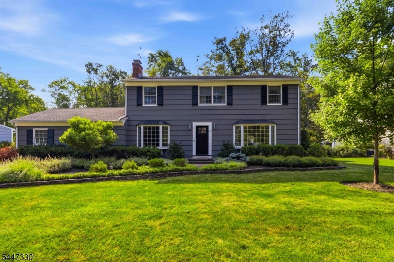 Welcome to this beautifully maintained 4-bedroom, 2.1-bath traditional Colonial in one of Convent Station's most desirable neighborhoods. Move-in ready and thoughtfully updated, this inviting home reflects true pride of ownership. Hardwood floors and detailed molding add warmth and character, while the spacious family room features a classic wood-burning fireplace. The expanded kitchen offers generous workspace and opens to a large, sun-filled dining area surrounded by windows perfect for everyday meals and entertaining. Stainless steel appliances, crisp white cabinetry, and convenient counter seating make this a kitchen you will truly enjoy. Upstairs are four comfortable bedrooms, including a private primary suite. The finished basement provides flexible space for recreation, exercise, work or play, while still offering ample storage. Outside, enjoy professional landscaping and a beautiful deck overlooking the peaceful Loantaka Park property beyond the backyard. Additional highlights include newer garage doors, a conveniently located mudroom, abundant closet space, wonderful natural light, and a floor plan designed for entertaining. Just a short jaunt to downtown Morristown, an easy drive to the Convent Station train, and ideally located to enjoy the shops, restaurants, recreation, and amenities of both Morristown and Madison.