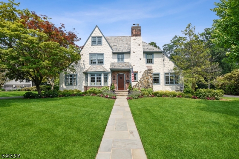 Stunning 5 Bedroom/ 5.1 Bath, designer-renovated home in Summit's prestigious Prospect Hill neighborhood. Fully reimagined Tudor with curated finishes and high-end upgrades throughout. The show-stopping kitchen features quartz counters, honed granite perimeter, Sub-Zero column refrigerators, a custom butcher block, working gas fireplace, warming drawer and hand-painted Italian marble tile. Expanded dining room with Phillip Jeffries wallpaper and window seat. Elegant powder room with brass and marble vanity. The family room includes a built-in recessed TV, wet bar, and custom window seating. Incredible primary suite with its own HVAC, walk-in closet, Steam Shower,Juliet balcony, antique mirrored fireplace, and hand-painted Chinoiserie wallpaper. Beautifully styled guest rooms on second and third floors. Additional highlights include three rebuilt gas fireplaces, three new HVAC systems, a Masterson heated pool with Lynx grill, Sonos sound system (interior + exterior), and hand-laid Italian tile in the foyer. Exceptional craftsmanship and thoughtful upgrades at every turn.
