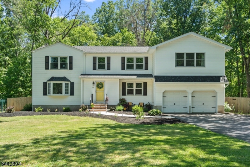 Beautifully renovated 5 bed, 3.5 bath colonial nestled on .74 acre of both manicured & scenic land in sought after Woodfield Estates. Featuring an expansive open concept floor plan, the lower level is perfect for entertaining w a 22x20 living rm complete w wood burning fireplace, new recessed lighting & sliding glass doors to backyard oasis. Updated kitchen includes stainless steel appliances, stone backsplash, granite countertops & refinished cabinetry w new hardware. 1st floor office provides ideal space for remote work while renovated powder room & laundry room (w brand new washer) both showcase elegant porcelain flooring. New primary suite added in 2025 provides apx 450 extra sq.ft. This luxurious retreat has cathedral ceiling & is flooded w natural light from 2 skylights. It includes 2 large walk-in closets (1 w washer dryer hookup) & a breathtaking bath w heated floor, 72-inch dual vanity, standalone soaker tub in custom wet room w pebble mosaic flooring & 4x4 windows overlooking nature. The 4 add'l bedrooms contain new stain resistant carpeting & 2 add'l full baths are sizable & bright. Basement features rec room w recessed lighting, storage room & a finished space currently used as an office. 2 decks are perfect for morning coffee or evening gatherings & an add'l deck behind shed equipped w a built-in bench, dartboard, Bluetooth speaker, & fire pit area for those starry nights. Located close to the Sourlands, Rt 206, shopping, etc. You don't want to miss this one!