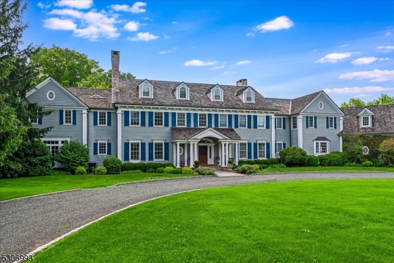 DRAMATIC PRICE IMPROVEMENT! Set on 44 open, rolling acres in Bedminster Hunt Country, an exceptional gated Colonial Revival estate with equestrian facilities is set along one of the township's most desirable lanes. Featured in NJ Design magazine, the sophisticated interiors create a relaxed ambiance characterized by rich colors and remarkable millwork. The expansive seven bedroom, eight full bath and two half-bath main residence is enriched by a three-stall horse barn featuring an attached three-car garage with a two-bedroom apartment above and an adjacent bonus room with kitchenette and full bath. Outside the main house, a generous patio and dual-covered side porches overlook sublime views of the acreage, while a pool tucked beyond a charming arbor and white picket fencing is lushly landscaped. Set far back from the road at the end of the long drive, this gracious property provides absolute privacy. Recording devices are on the premises.