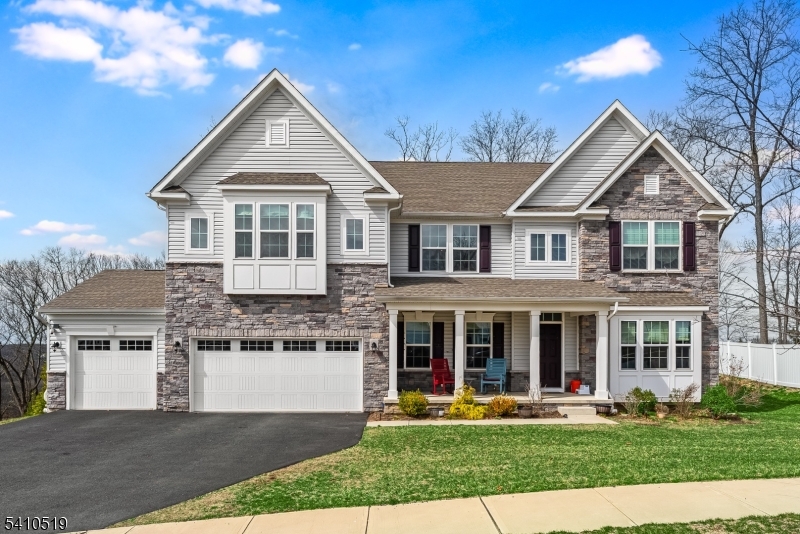 Perched at one of the highest elevations in Stone Water Village, this exceptional East-facing Corsica model offers panoramic skyline views and nearly-new construction without the wait. Featuring a sought-after 4-foot extension and over $150,000 in upgrades, this beautifully positioned home blends luxury, space, and lifestyle. Step inside to soaring ceilings and a dramatic entryway leading into bright, open-concept living spaces filled with natural light. The chef-inspired kitchen showcases an oversized center island, upgraded appliances, walk-in pantry, and seamless flow into the dining and living areas anchored by a cozy fireplace. A first-floor bedroom and full bath provide flexibility for guests, extended living, or a private office.Upstairs, a spacious loft creates the perfect second living area. The luxurious primary suite features tray ceilings, dual walk-in closets, and a spa-like bath. Four additional spacious bedrooms and an upstairs laundry room complete this thoughtfully designed level.The finished lower level adds nearly 1,400 sq ft of additional living space with a media room, bedroom, full bath, and endless possibilities for recreation, fitness, or guest space. Outside, an expansive rear deck delivers breathtaking 180-degree views. Complete with a covered front porch, 3-car garage, and convenient access to shopping, dining, marinas, highways, and top-rated schools.