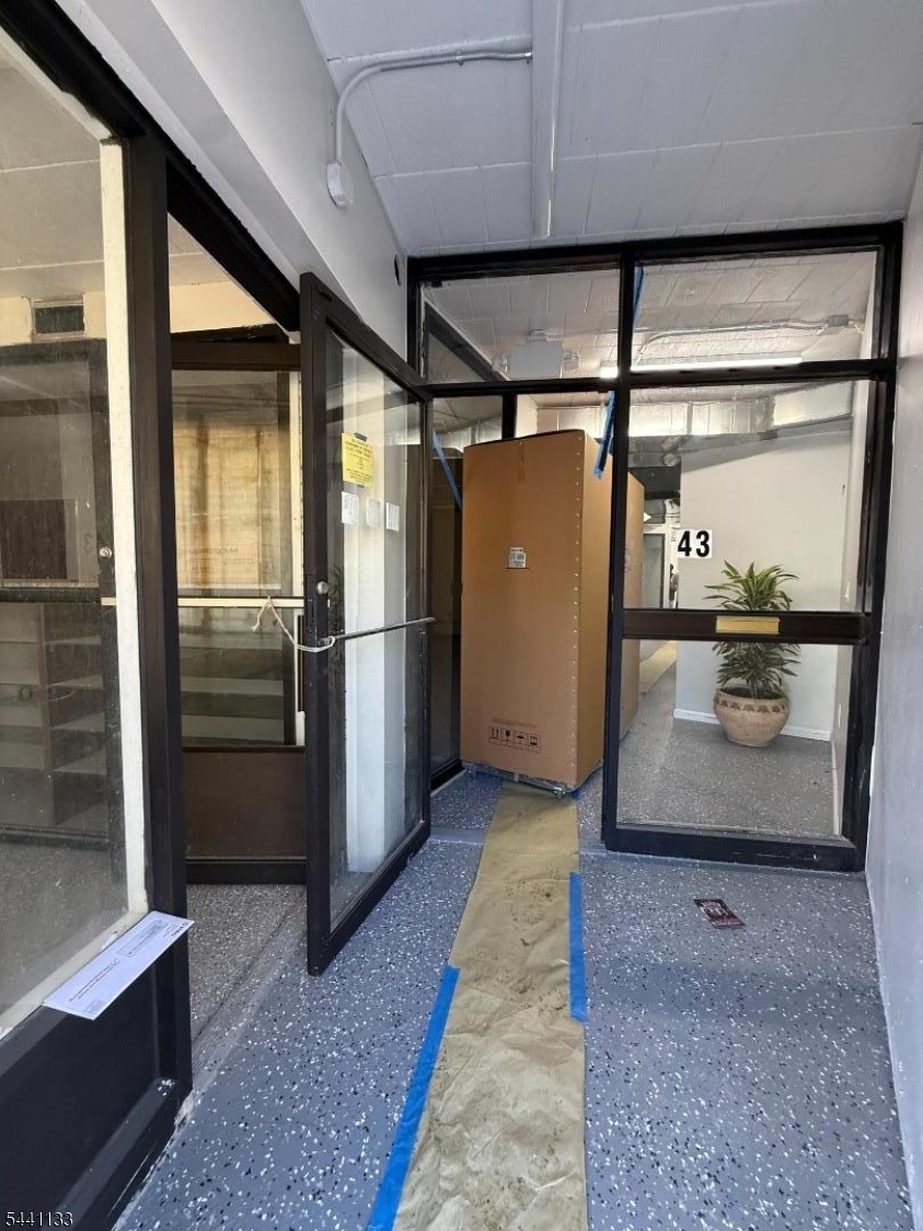 Excellent opportunity to lease a beautifully renovated commercial space at 18 Orange Avenue, ideally located just around the corner from the bustling Springfield Avenue business district. This versatile storefront offers good visibility, foot traffic, and the rare convenience of an exclusive private parking lot for tenants and customers. The space features a spacious open storefront with large glass entry doors, creating an inviting environment ideal for retail, professional services, medical, beauty, or office use. In addition to the main open area, there are three separate private rooms that can be used as offices, consultation rooms, storage, or meeting spaces. Recently renovated throughout, the property offers central air conditioning, a modern interior, and a move-in-ready layout. All utilities are included, making budgeting simple and predictable.