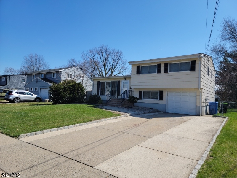 Well maintained split-level home with an attached garage located in a highly desirable neighborhood. This lovely residence features 3 bedrooms and 2 full baths. The main level includes an eat-in kitchen that leads to a formal dining room, as well as a spacious living room with high ceilings. The ground level provides a second full bath, a laundry area, and a versatile room suitable for a home office, recreation room, or guest area. Additionally, the heating, central air, and windows were all updated approximately four years ago. The property also boasts a large, private backyard that offers ample space for entertaining, outdoor activities, or relaxation.