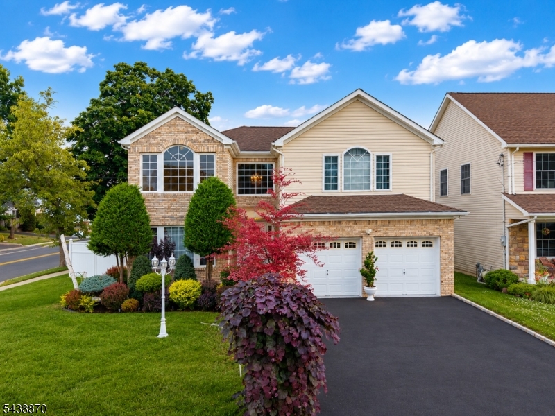 Exceptional 4-bedroom, 3 full and 1 half bath Colonial located in the highly coveted Putnam Manor section of Union, one of the township's most distinguished and sought-after neighborhoods. Thoughtfully designed for both everyday living and elegant entertaining, this impressive residence offers approximately 3,000 square feet of well-appointed living space. One of the community's most beautifully landscaped properties, complete with an underground sprinkler system, the grounds remain lush and vibrant throughout the seasons. A grand foyer welcomes you into formal living and dining rooms, while the spacious family room features a gas fireplace. The oversized eat-in kitchen offers a center island, separate dining area, and abundant cabinetry. The luxurious primary suite includes a walk-in closet and spa-inspired bath with a jetted tub and separate stall shower. Additional highlights include cathedral ceilings, hardwood and tile flooring, first-floor laundry, central vacuum, security system, finished basement with recreation and storage areas, a built-in 2-car garage, and zone heating and cooling. Ideally situated on a prominent corner lot in prestigious Putnam Manor, residents enjoy picturesque tree-lined streets, neighborhood pride, and convenient access to NYC transportation, major highways, Newark Liberty International Airport, shopping, dining, Kawameeh Park, and the Elizabeth River Trail. A rare opportunity to own in one of Union's premier residential enclaves.