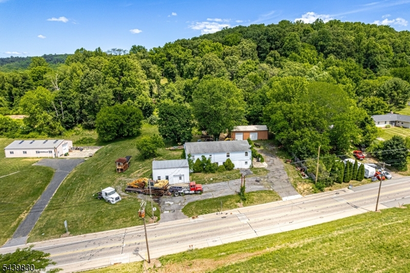 Exceptional mixed-use investment opportunity with endless potential! This highly visible highway-front property features approximately 3,240 SF of commercial space, a spacious 4-bedroom apartment above, needs TLC, and a separate 25' x 45' pole barn with double 10' x 10' doors. An additional 600 SF of unused commercial space and 1,125 SF within the pole barn provide excellent opportunities for added income. The property offers outstanding exposure with a free-standing sign, separate entrance and exit driveways, ample parking on both sides, and separate utilities. Ideal for owner-occupants, investors, or businesses seeking multiple income streams in a prime location.