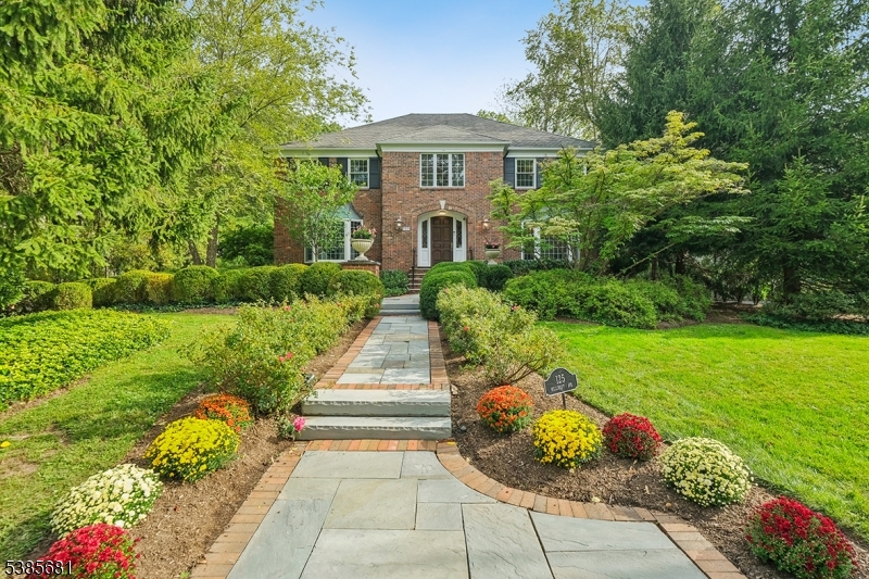Set on nearly 3/4 of an acre on Summit's highly desirable Northside, this stately brick Georgian Colonial offers exceptional privacy with lush landscaping surrounding an unusually large, deep backyard and expansive bluestone patio with built-in grill. Inside, enjoy expansive living space including formal and informal rooms with gorgeous built-ins and coffered ceilings, a chef's kitchen anchored by a stunning LaCornue stove/oven, and a sun-drenched conservatory with soaring ceilings and walls of windows. The second floor features five spacious bedrooms, including a luxurious primary suite with dual walk-in closets and spa-like bath. Enjoy the convenience of front and back staircases and a first floor mud/laundry room near back door and oversized attached 2-car garage. Space, privacy, location and style -- this home has it all!