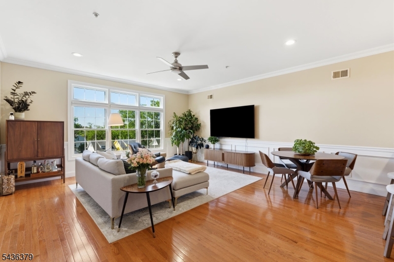 Move right into this beautifully updated and meticulously maintained condo in desirable Springfield Commons. This sun-filled unit features beautiful hardwood floors, abundant natural light, crown molding, and a freshly painted interior. The modern kitchen offers quality appliances, stylish finishes, and ample cabinet space, while the updated bathrooms provide a clean, contemporary feel. Enjoy your private balcony and the convenience of an elevator building with assigned garage parking (#15), bike storage, and additional storage space. The building is equipped with a full sprinkler system and smart carbon monoxide system for added peace of mind. Ideally located directly across from Maplecrest Park and the Maplewood Library, this home offers easy access to shopping, dining, transportation. Enjoy all that Maplewood has to offer, including highly rated schools, parks, libraries, dining, and convenient access to NYC transportation. A true move-in ready opportunity combining comfort, convenience, and modern finishes in one of Maplewood's most desirable communities.