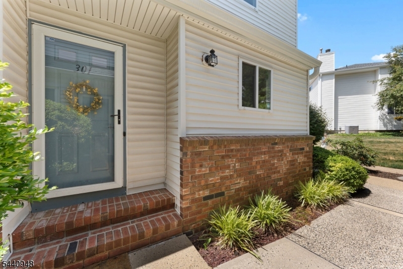 Incredibly maintained and beautifully updated 2 bed, 1.5 bath end unit townhome with full basement and primary balcony in desirable Stonegate.  This unit boasts an updated kitchen with stainless steel appliances, granite countertops, mosaic backsplash and ceiling height cabinetry.  This open concept floor plan includes a separate dining area adjacent to a sizable living room with a modern, cozy gas fireplace, and an independent sitting area with sliding glass doors to a quaint deck.  Two large bedrooms and a gorgeously renovated main bath with glossy blue ceramic subway tile shower, porcelain floor tile, and white cultured marble top vanity located upstairs.  Walk in closet in primary bedroom as well as a balcony on which to relax and unwind after a long day.  Full basement with laundry room and considerable space to create your own recreation room or office or simply keep for storage and utility.  Community contains tennis courts and association pool!  Close to downtown Flemington, shopping, restaurants and Rt. 202.  Nothing to do but unpack an move in!  You don't want to miss this one!!