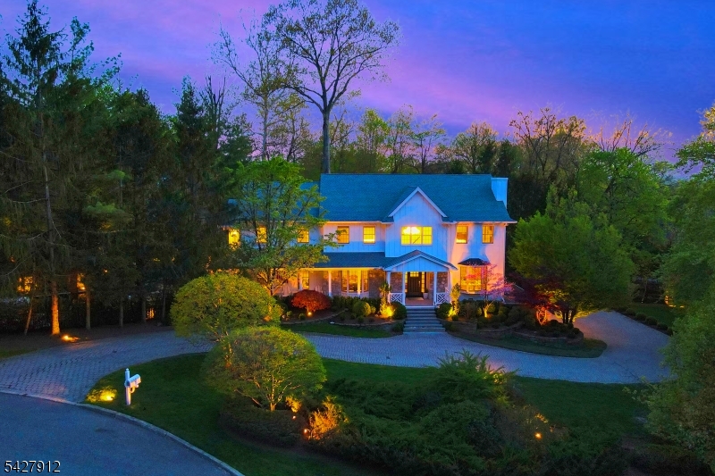 Perched atop Norwood's East Hill, this fully renovated modern farmhouse offers approx. 6,400 sq ft on over 1.5 private acres backing to 300 acres ofpreserved parkland with direct trail access and exceptional privacy. Soaring ceilings, expansive windows, and a sun-filled great room highlight theopen layout. The chef's kitchen with Thermador appliances and custom Amish cabinetry anchors the main living areas, complemented by threefireplaces throughout the home. First floor features a guest bedroom and expansive home office, with sliding doors to a wraparound deck overlookingthe pool. The finished lower level includes a home theater, gym, custom bar, and yard access. Upgrades include new flooring, designer baths withradiant heat, smart-home features, a 10-camera security system, and California Closets throughout. Exterior updates feature Hardie siding, a rebuiltporch, Trex decking, and landscaped grounds with a 65-light LED outdoor lighting system, a black lagoon-style pool/spa, waterfall, outdoor kitchen,and gas fire pit. 3-car garage. Cul-de-sac location near top schools and NYC access.
