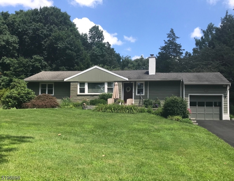 Highest and Best offers due Thursday Jan 12 at 5pm. Lake Lenape living at its best! Located just 3 blocks from the lake, this home is perfectly situated to take full advantage of all this wonderful community has to offer. Enjoy seasonal views of the lake from the paver front patio with built-in fire pit. Inside, prepare to be impressed by the craftsmanship, style, and beauty of hardwood floors, walls adorned with custom wainscoting, and a stunning bluestone hearth featuring a Vermont Castings fireplace insert. Updated eat-in kitchen features granite countertops, stainless appliances, and a pantry. Sliding glass doors bring you to the back screened-in porch and fenced-in yard. The lower level is completely finished featuring a large multi-purpose room with a tile floor and recessed lighting, a full bath, and a kitchenette - perfect space for guests or entertaining. Outdoors, enjoy the privacy of your patio and mature landscaping while relaxing in the hot tub. This perfect house is ready to be your home. Lake Lenape membership is optional currently $440.00 annually or senior membership $266.